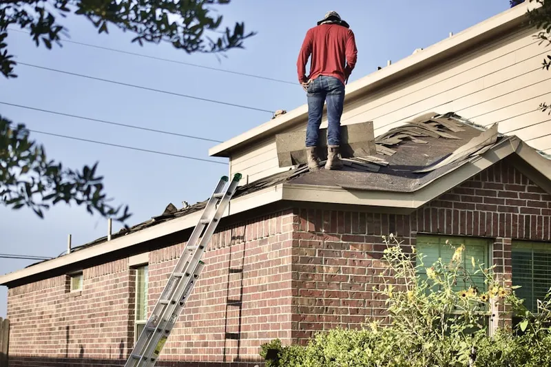 Professional roofer working on a residential roof in Fort Hunt